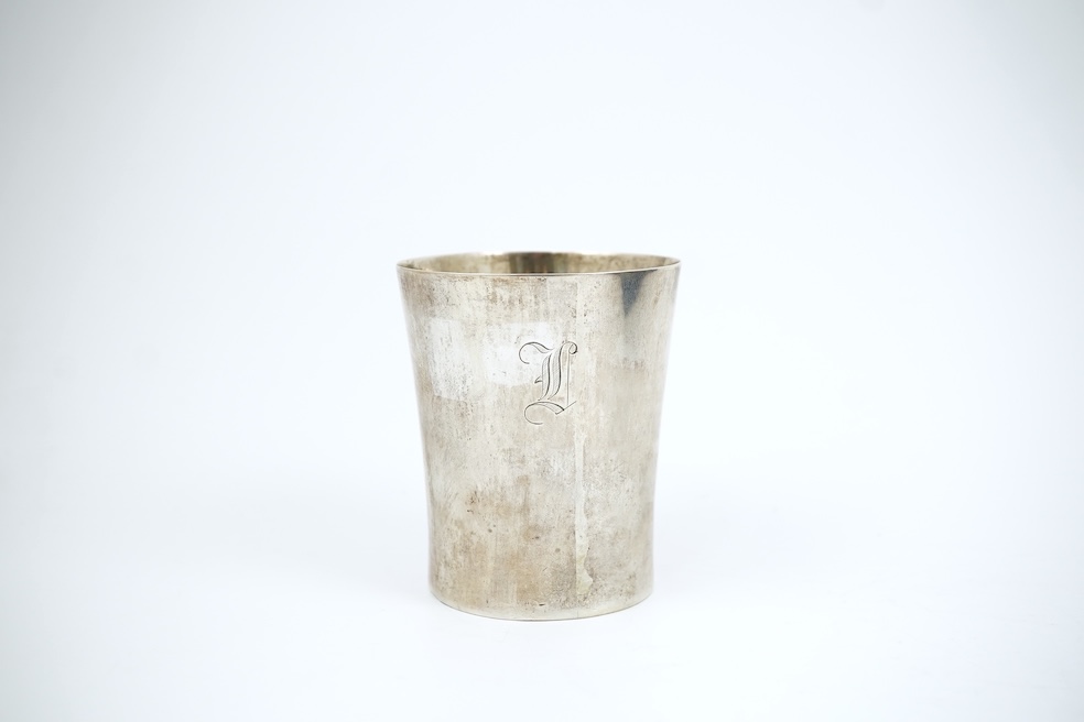 A white metal beaker the base inset with a silver medal commemorating the Peace of Oliva, 1660, Obv. Bird's-eye view of the city of Danzig with troops moving in foreground; above, an eagle crowned, an olive branch in its